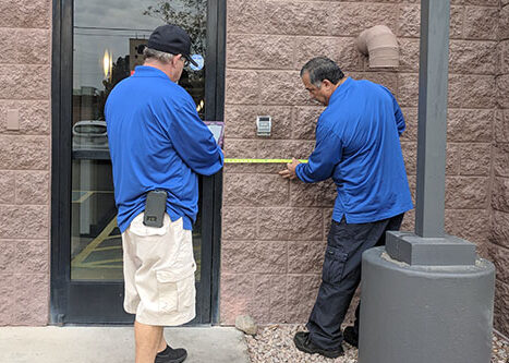 Two Life Quest team members measuring entrance maneuvering clearance
