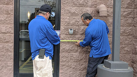 Two Life Quest team members measuring entrance maneuvering clearance
