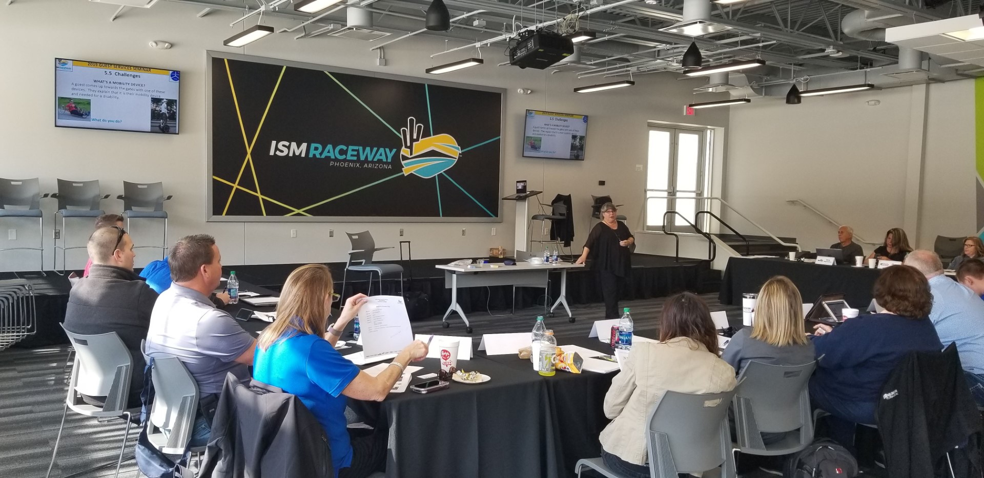 Dr. Nanette Odell leading a presentation for a small group of people at ISM Raceway