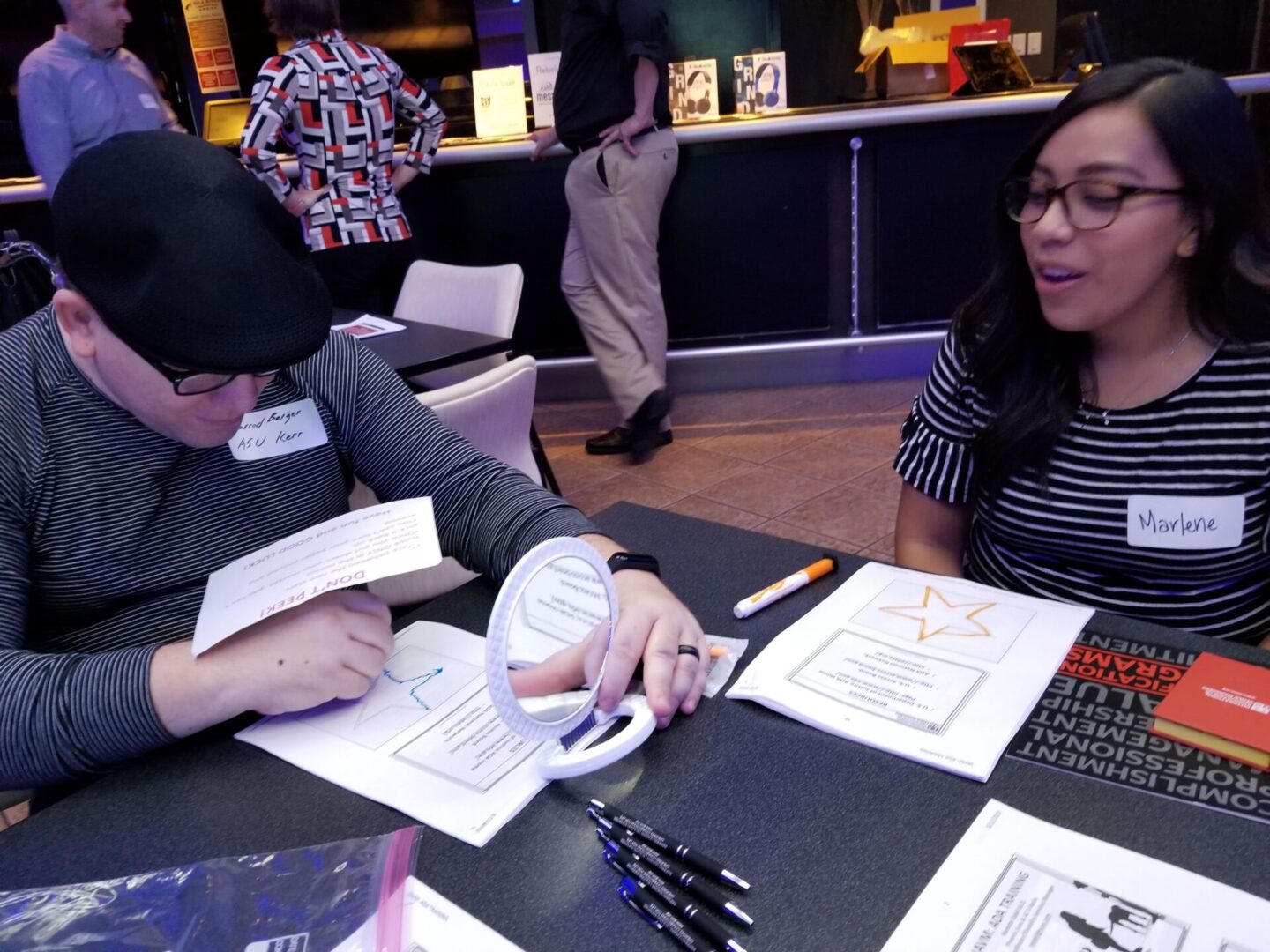 Close up of two employees doing a disability inclusion activity.